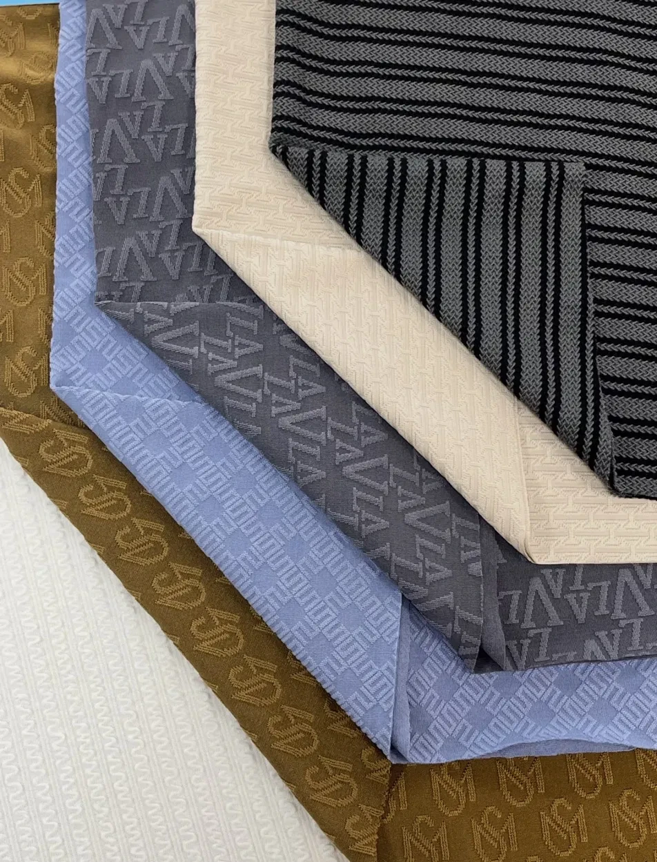 Layered knitted jacquard fabrics in brown, blue, grey and cream