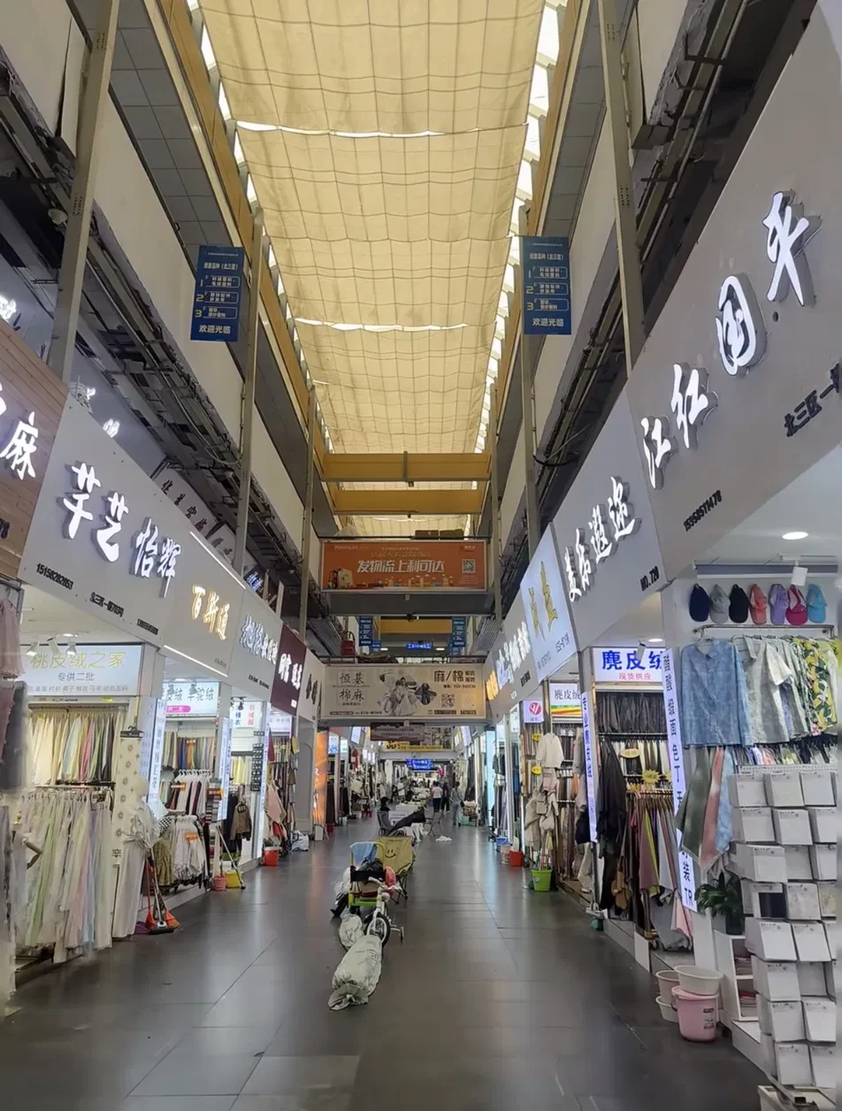 Wholesale fabric market hall lined with fabric shops