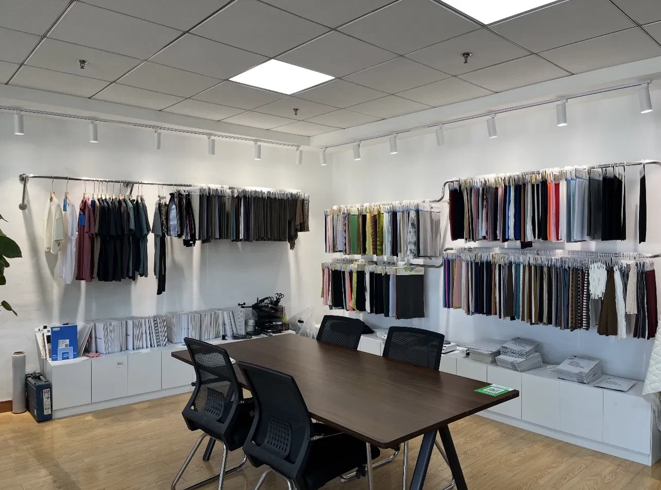Sino Fabric sample room with garment samples and fabric swatches on the walls
