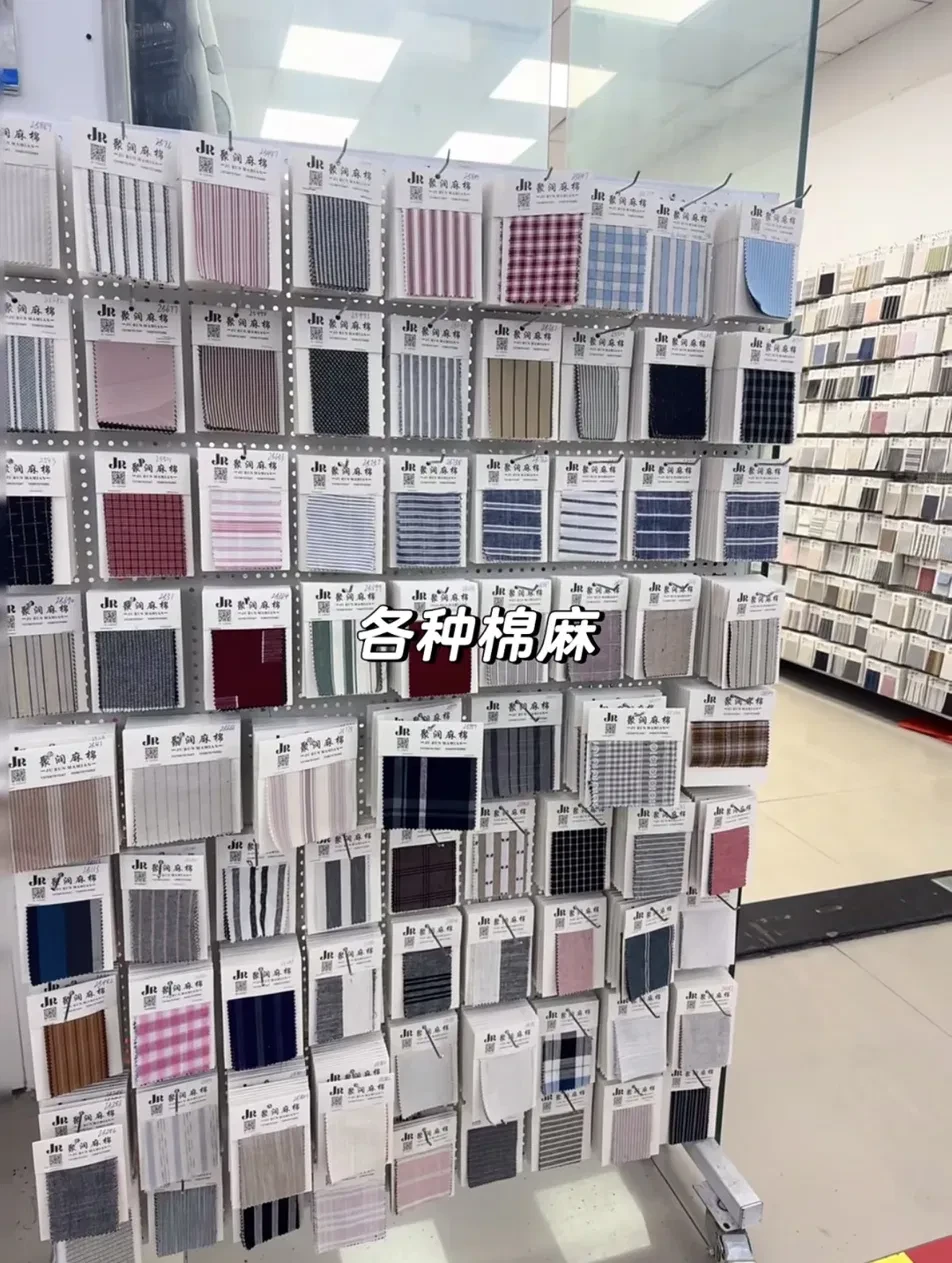 Wall of cotton and linen swatch cards in stripes and checks